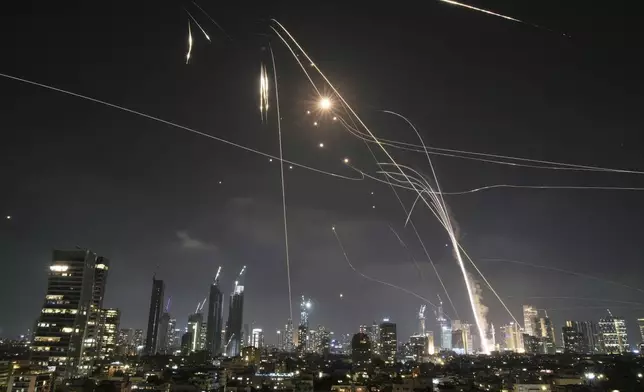 Israeli Iron Dome air defense system fires to intercept missiles over Tel Aviv, Israel, Friday, June 13, 2025. (AP Photo/Leo Correa)