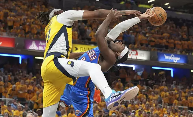 Oklahoma City Thunder guard Luguentz Dort, right, tries to shoot over Indiana Pacers center Myles Turner during the second half of Game 4 of the NBA Finals basketball series, Friday, June 13, 2025, in Indianapolis. (AP Photo/Michael Conroy)