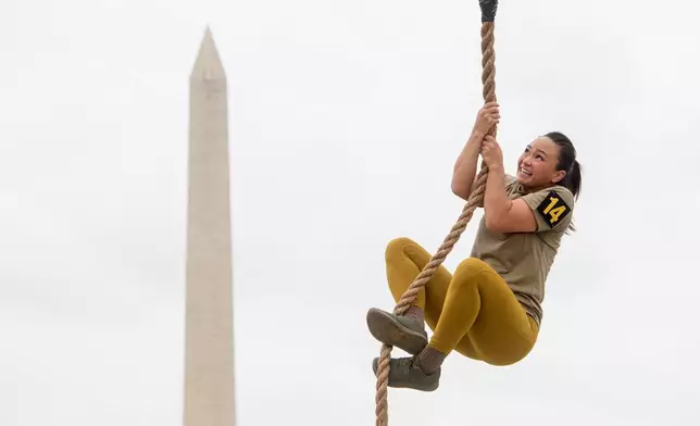 A team member competes in the rope climb portion of the Army fitness competition during the festival event to honor the Army's 250th anniversary, coinciding with President Donald Trump's 79th birthday, Saturday, June 14, 2025, on the National Mall in Washington. (AP Photo/Rod Lamkey, Jr.)