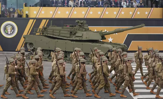 Soldiers from the Army 82nd Airborne Division, dressed in World War I era uniforms, march past the reviewing stand and President Donald Trump during a military parade commemorating the Army's 250th anniversary, coinciding with his 79th birthday, Saturday, June 14, 2025, in Washington. (AP Photo/Julia Demaree Nikhinson)