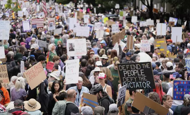 Demonstrators take part in the "No Kings" protest, Saturday, June 14, 2025, in Portland, Ore. (AP Photo/Jenny Kane)