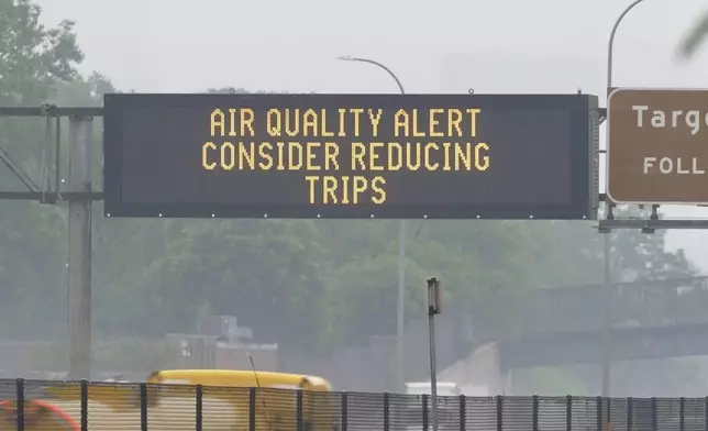 A sign warns of an air quality alert as smoke from wildfires burning in Canada reaches Minneapolis, Minn., on Tuesday, June 3, 2025. (AP Photo/Mark Vancleave)
