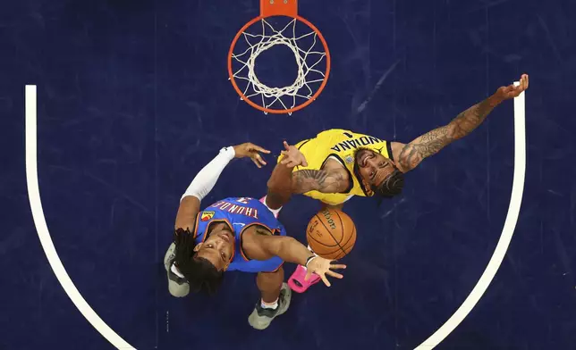 Oklahoma City Thunder forward Dillon Jones (3) Indiana Pacers forward Obi Toppin (1) fight for a rebound during the second half of Game 6 of the NBA Finals basketball series, Thursday, June 19, 2025, in Indianapolis. (Maddie Meyer/Pool Photo via AP)