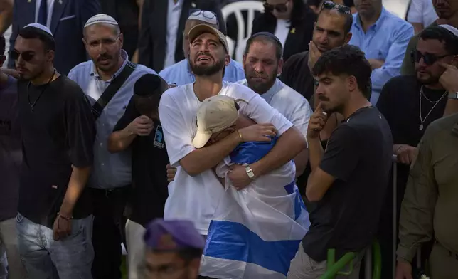 Mourners attend the funeral of Israeli soldier Sgt. Omer Van Gelder, who was killed in a battle in the Gaza Strip, at the Mount Herzl military cemetery in Jerusalem, Tuesday, June 3, 2025. (AP Photo/Ohad Zwigenberg)