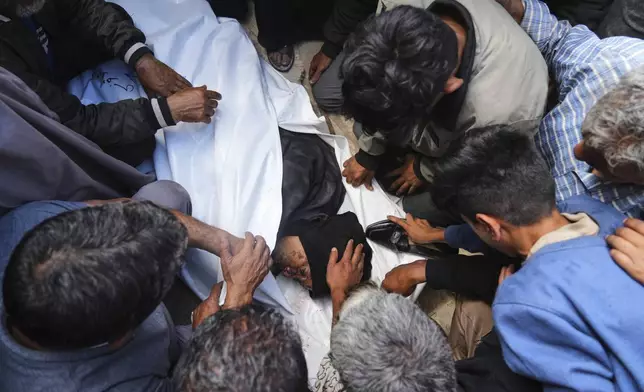 Palestinians mourn over the body of Reem Al-Akhras who was killed while heading to a Gaza aid hub, during her funeral at the Nasser Hospital in Khan Younis, southern Gaza Strip, Tuesday, June 3, 2025. (AP Photo/Abdel Kareem Hana)