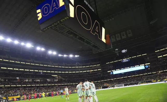 Mexico players celebrate a goal by defender César Montes (3) against Suriname during a CONCACAF Gold Cup soccer match Wednesday, June 18, 2025, in Arlington, Texas. (AP Photo/Julio Cortez)
