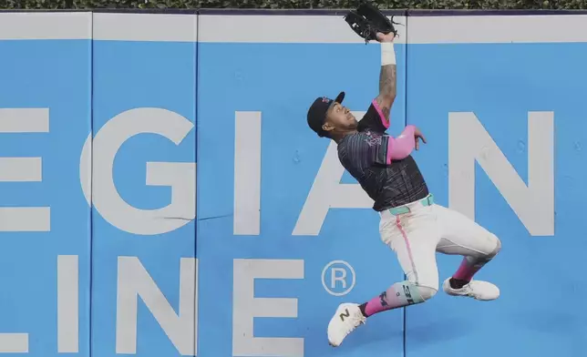 Miami Marlins right fielder Dane Myers catches a fly ball hit by San Francisco Giants' Jung Hoo Lee during the seventh inning of a baseball game, Saturday, May 31, 2025, in Miami. (AP Photo/Lynne Sladky)