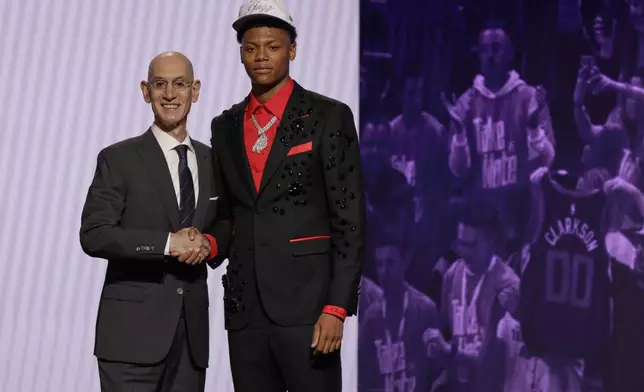 Ace Bailey poses for a photo with NBA commissioner Adam Silver after being selected fifth by the Utah Jazz in the first round of the NBA basketball draft, Wednesday, June 25, 2025, in New York. (AP Photo/Adam Hunger)
