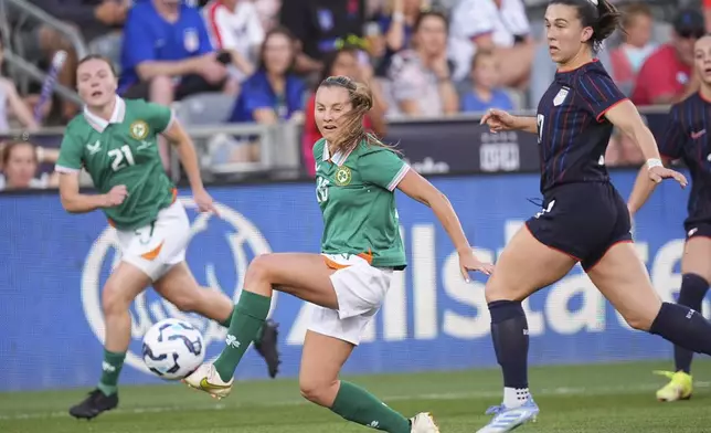 Ireland forward Kyra Carusa, center, passes the ball as United States national team midfielder Sam Coffey, front right, defends in the first half of an international women's friendly soccer match Thursday, June 26, 2025, in Commerce City, Colo. (AP Photo/David Zalubowski)