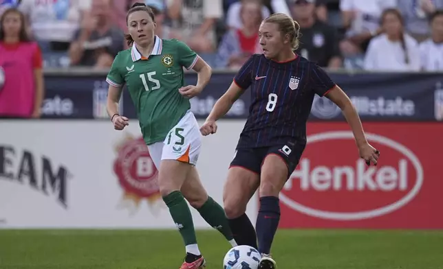United States national team defender Avery Patterson, right, passes the ball as Ireland forward Lucy Quinn, left, defends in the first half of an international women's friendly soccer match Thursday, June 26, 2025, in Commerce City, Colo. (AP Photo/David Zalubowski)