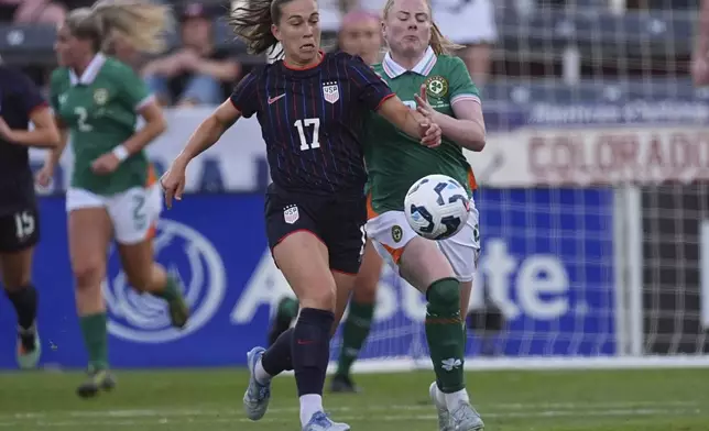 United States national team midfielder Sam Coffey (17) pursues the ball with Ireland forward Amber Barrett, right, in the first half of an international women's friendly soccer match Thursday, June 26, 2025, in Commerce City, Colo. (AP Photo/David Zalubowski)