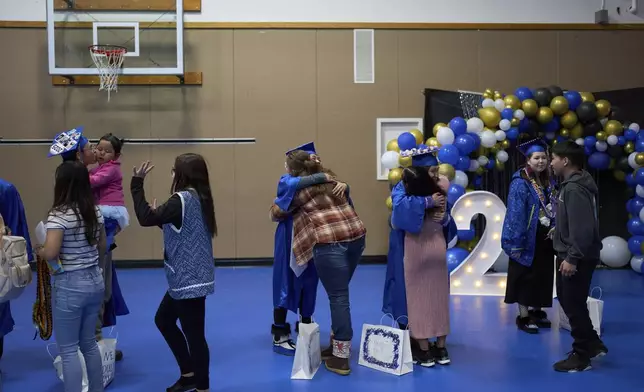 Community and family members congratulate graduating students from the Galena Interior Learning Academy during a ceremony Wednesday, May 21, 2025, in Galena, Alaska. (AP Photo/John Locher)