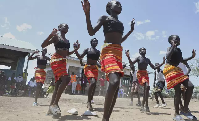 Young refugee children from the Acholi Dancers group rehearse their traditional dance at a Child-Friendly Space within the Kalobeyei Refugee Settlement in Turkana, Kenya, Monday, June 2, 2025. (AP Photo/Andrew Kasuku)