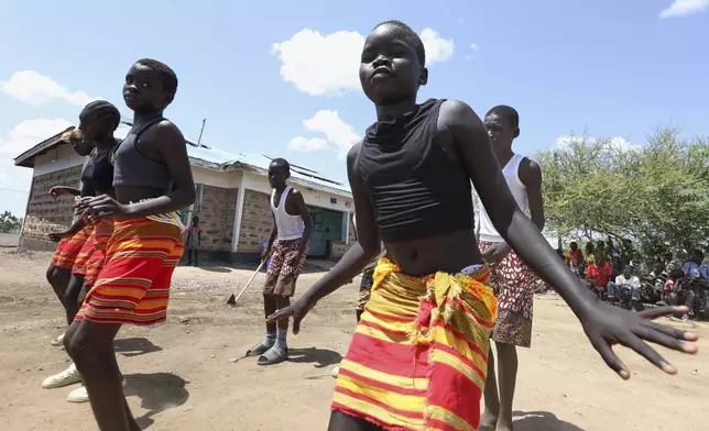 Young refugee children from the Acholi Dancers group rehearse their traditional dance at a Child-Friendly Space within the Kalobeyei Refugee Settlement in Turkana, Kenya, Monday, June 2, 2025. (AP Photo/Andrew Kasuku)