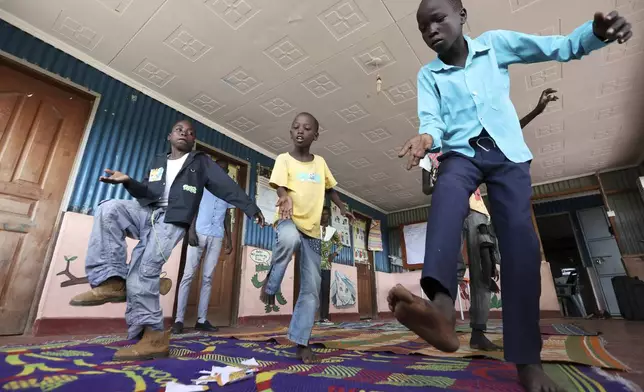 Young refugee children from the Robot Boys group practices robot dance at a Child-Friendly Space in the Kalobeyei Refugee Settlement in Turkana, Kenya, Monday, June 2, 2025. (AP Photo/Andrew Kasuku)