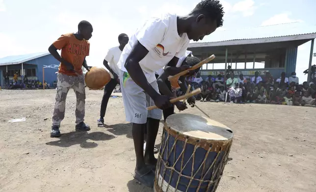 Young refugee children from the Acholi Dancers group rehearse their traditional dance at a Child-Friendly Space within the Kalobeyei Refugee Settlement in Turkana, Kenya, Monday, June 2, 2025. (AP Photo/Andrew Kasuku)