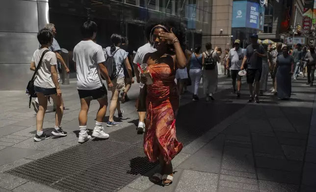 A woman wipes her brow during a heatwave on Tuesday, June 24, 2025, in New York. (AP Photo/Olga Fedorova)