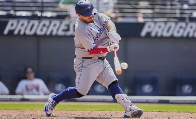 Toronto Blue Jays' Alejandro Kirk hits a single in the ninth inning of a baseball game against the Cleveland Guardians in Cleveland, Thursday, June 26, 2025. (AP Photo/Sue Ogrocki)