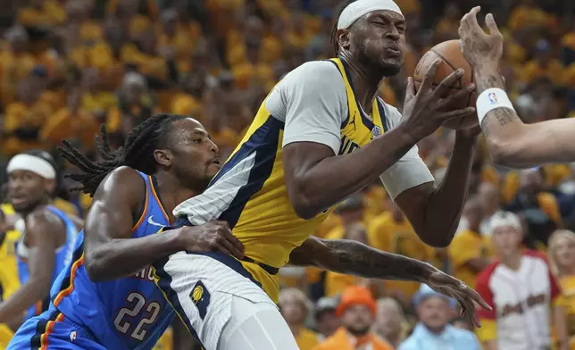Indiana Pacers center Myles Turner is pressured by Oklahoma City Thunder guard Cason Wallace (22) during the first half of Game 4 of the NBA Finals basketball series, Friday, June 13, 2025, in Indianapolis. (AP Photo/Michael Conroy)