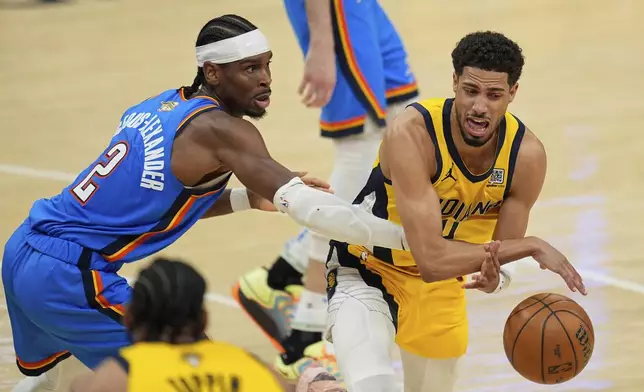 Indiana Pacers guard Tyrese Haliburton (0) loses the ball under pressure from Oklahoma City Thunder guard Shai Gilgeous-Alexander (2) during the second half of Game 3 of the NBA Finals basketball series, Wednesday, June 11, 2025, in Indianapolis. (AP Photo/Abbie Parr)