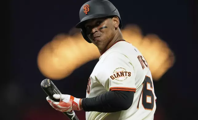 San Francisco Giants' Rafael Devers walks to the dugout after hitting a fly ball to Cleveland Guardians left fielder Steven Kwan for an out during the eighth inning of a baseball game Wednesday, June 18, 2025, in San Francisco. (AP Photo/Godofredo A. Vásquez)