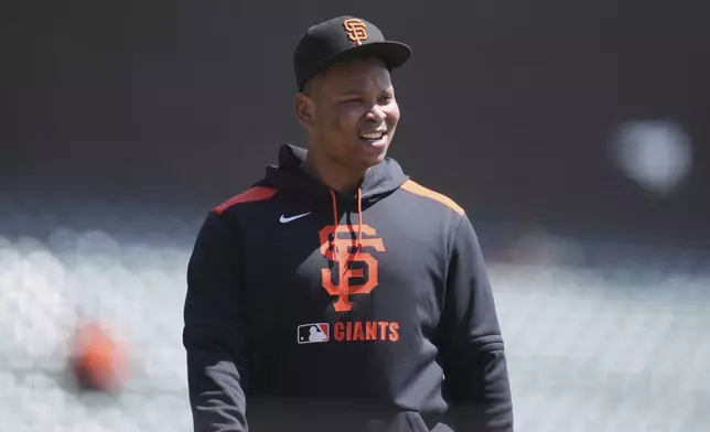San Francisco Giants' Rafael Devers walks onto the field before a baseball game against the Cleveland Guardians in San Francisco, Thursday, June 19, 2025. (AP Photo/Jeff Chiu)