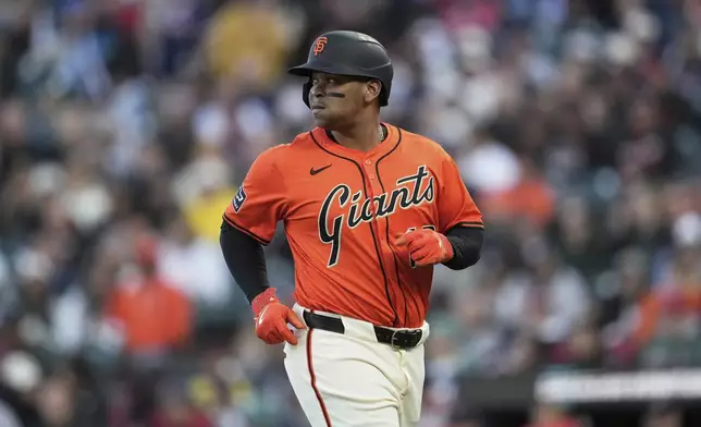 San Francisco Giants' Rafael Devers jogs to the dugout after grounding out against the Boston Red Sox during the first inning of a baseball game in San Francisco, Friday, June 20, 2025. (AP Photo/Jeff Chiu)