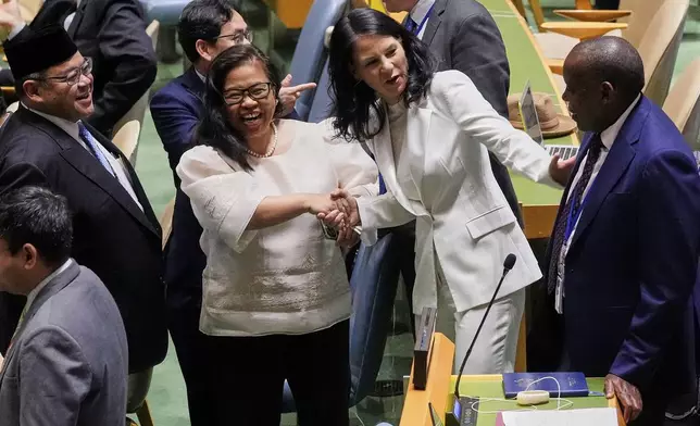 Annalena Baerbock of Germany, second from right, talks with delegates in the United Nations General Assembly, Monday, June 2, 2025. (AP Photo/Richard Drew)