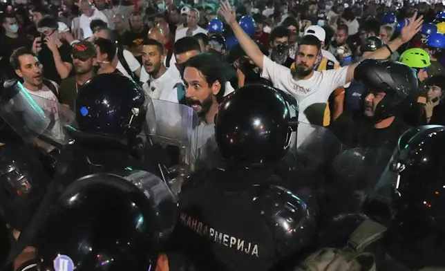 Riot police block anti-government protesters at the end of a rally pressing for an early election after nearly eight months of almost daily anti-corruption demonstrations that have shaken the populist government of President Aleksandar Vucic, in Belgrade, Serbia, Saturday, June 28, 2025. (AP Photo/Darko Vojinovic)