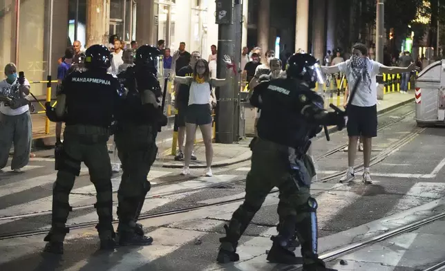 Riot police charge protesters at the end of an anti-government rally pressing for an early election after nearly eight months of almost daily anti-corruption demonstrations that have shaken the populist government of President Aleksandar Vucic, in Belgrade, Serbia, Saturday, June 28, 2025. (AP Photo/Darko Vojinovic)