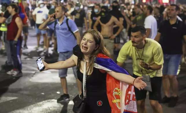 People react at the end of a rally pressing for an early election after nearly eight months of almost daily anti-corruption demonstrations that have shaken the populist government of President Aleksandar Vucic, in Belgrade, Serbia, Saturday, June 28, 2025. (AP Photo/Marko Drobnjakovic)