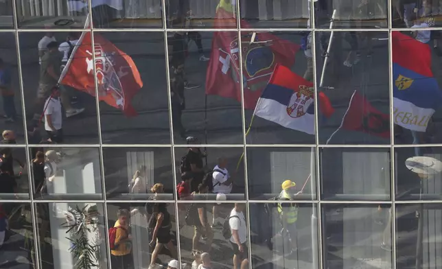 People attend a major anti-government rally to press their demand for an early election after nearly eight months of almost daily anti-corruption demonstrations that have shaken the populist government of President Aleksandar Vucic, in Belgrade, Serbia, Saturday, June 28, 2025. (AP Photo/Marko Drobnjakovic)