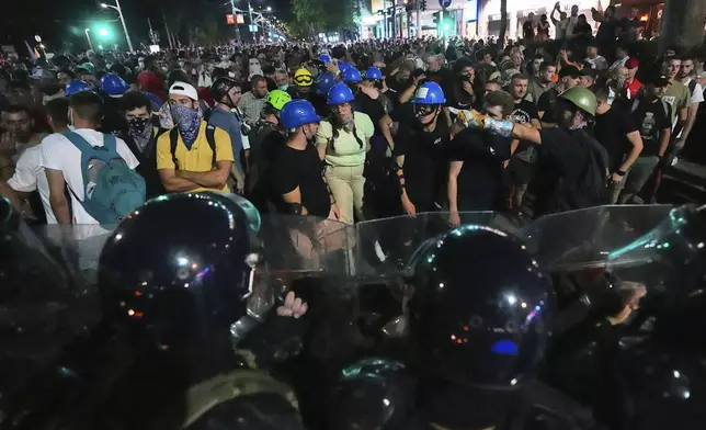 Riot police block anti-government protesters at the end of a rally pressing for an early election after nearly eight months of almost daily anti-corruption demonstrations that have shaken the populist government of President Aleksandar Vucic, in Belgrade, Serbia, Saturday, June 28, 2025. (AP Photo/Darko Vojinovic)