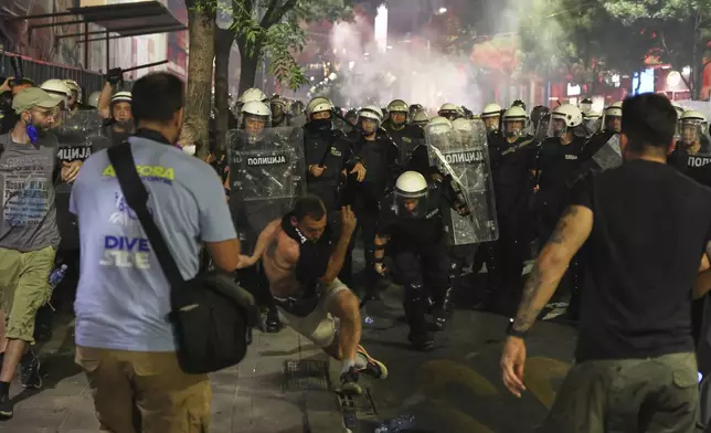 Riot police block anti-government protesters at the end of a rally pressing for an early election after nearly eight months of almost daily anti-corruption demonstrations that have shaken the populist government of President Aleksandar Vucic, in Belgrade, Serbia, Saturday, June 28, 2025. (AP Photo/Marko Drobnjakovic)