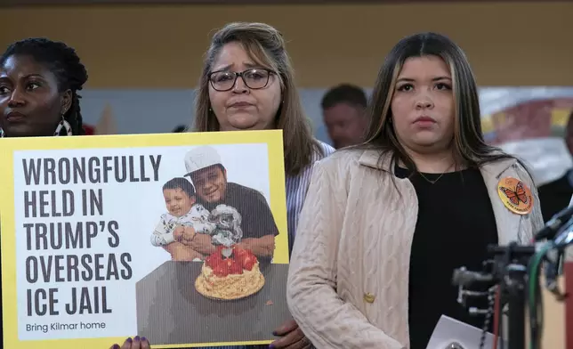 FILE - Jennifer Vasquez Sura, the wife of Kilmar Abrego Garcia of Maryland, who was mistakenly deported to El Salvador, right, stands with supporters during a news conference at CASA's Multicultural Center in Hyattsville, Md., April 4, 2025. (AP Photo/Jose Luis Magana, FIle)