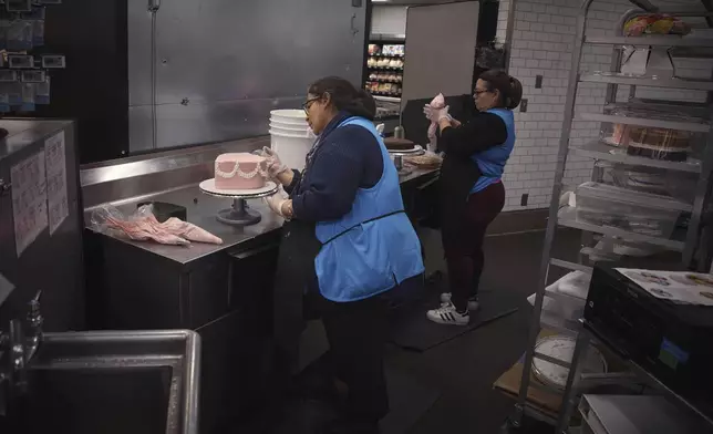 Employees make cakes inside Walmart Supercenter on Wednesday, May 28, 2025, in North Bergen, N.J. (AP Photo/Andres Kudacki)