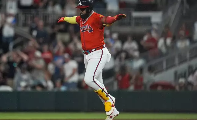 Atlanta Braves designated hitter Marcell Ozuna (20) celebrates his three-run homer against the Colorado Rockies in the seventh inning of a baseball game, Friday, June 13, 2025, in Atlanta. (AP Photo/Mike Stewart)