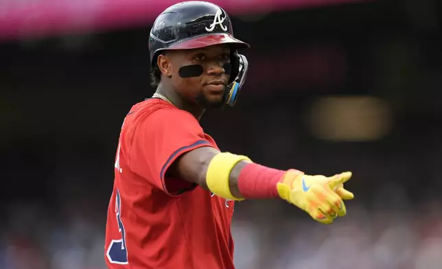 Atlanta Braves outfielder Ronald Acuña Jr. (13) speaks to the Colorado Rockies bench in the first inning of a baseball game, Friday, June 13, 2025, in Atlanta. (AP Photo/Mike Stewart)