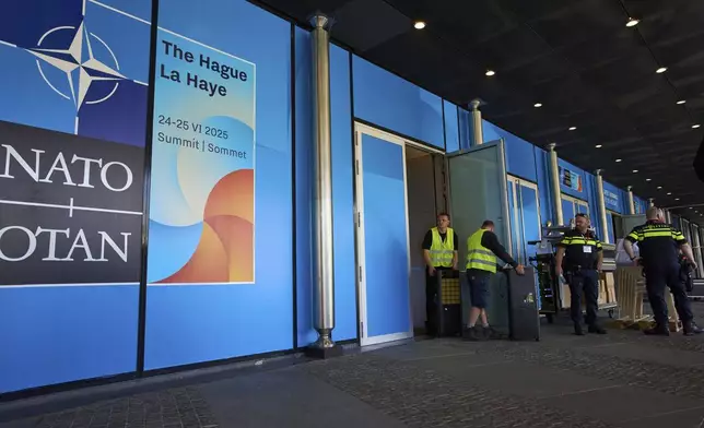 Dutch police guard an entrance to the summit site ahead of the NATO summit in The Hague, Netherlands, Wednesday, June 18, 2025. (AP Photo/Peter Dejong)