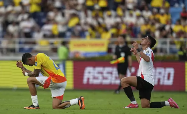 Colombia's Daniel Munoz, left, and Peru's Cesar Inga react at the end of the game for a World Cup 2026 qualifying soccer match at Metropolitano stadium in Barranquilla, Colombia, Friday, June 6, 2025. (AP Photo/Fernando Vergara)
