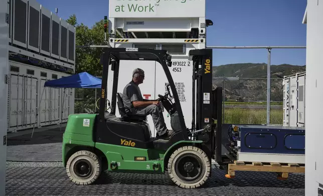 An employee drives a forklift at Energy Vault, a company that is creating an emergency power system that relies on hydrogen and battery storage, on Tuesday, May 27, 2025, in Calistoga, Calif. (AP Photo/Annika Hammerschlag)