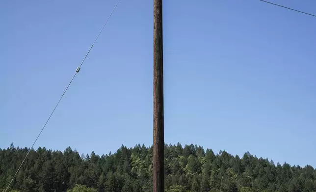 A power line connected to the grid stands in Calistoga, Calif., Tuesday, May 27, 2025. It will carry electricity from a backup system powered by hydrogen and batteries. (AP Photo/Annika Hammerschlag)