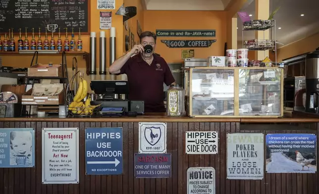 Calistoga Roastery owner Clive Richardson sips coffee behind the counter Tuesday, May 27, 2025, in Calistoga, Calif. (AP Photo/Annika Hammerschlag)