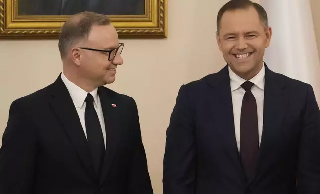 Poland's outgoing President Andrzej Duda, left, welcomes the President Elect Karol Nawrocki at the Presidential Palace in Warsaw, Poland, Tuesday, June 3, 2025. (AP Photo/Czarek Sokolowski)
