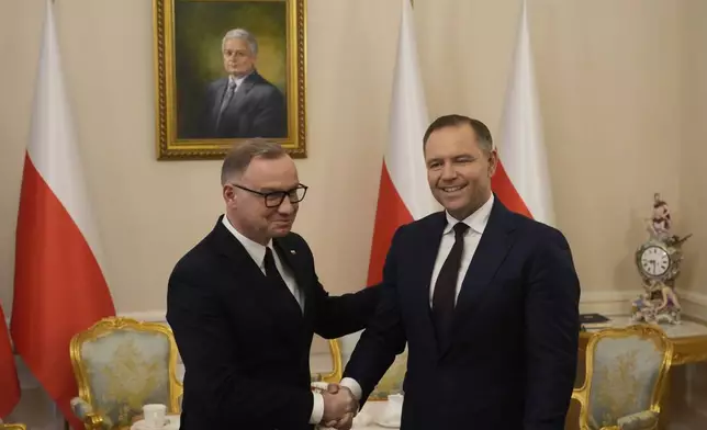 Poland's outgoing President Andrzej Duda, left, welcomes the President Elect Karol Nawrocki at the Presidential Palace in Warsaw, Poland, Tuesday, June 3, 2025. (AP Photo/Czarek Sokolowski)