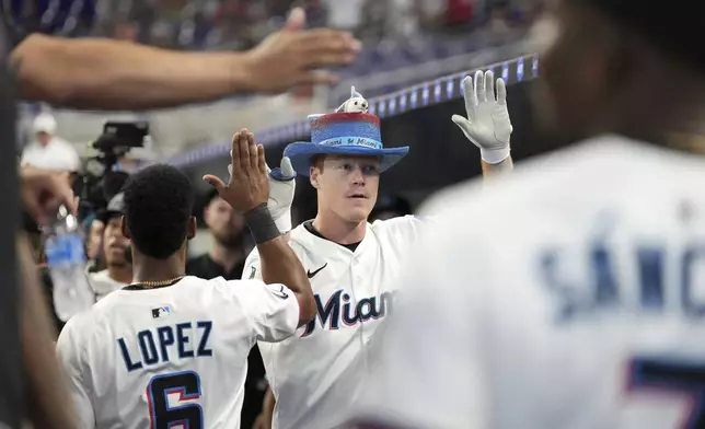 Miami Marlins' Eric Wagaman, center, celebrates with teammates after hitting a two-run homer in the second inning of a baseball game against the Philadelphia Phillies, Tuesday, June 17, 2025, in Miami. (AP Photo/Rebecca Blackwell)