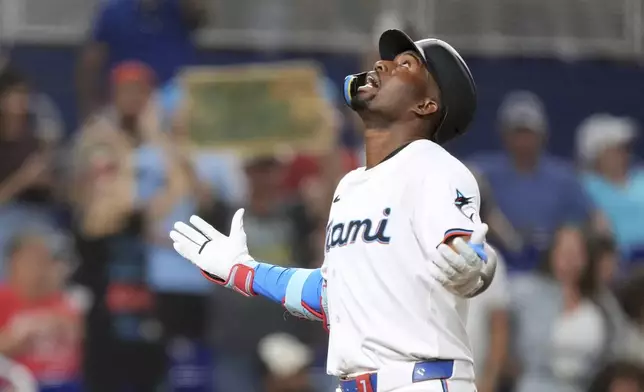 Miami Marlins' Jesus Sanchez celebrates as he runs to home after centering on a line drive in the seventh inning of a baseball game against the Philadelphia Phillies, Tuesday, June 17, 2025, in Miami. (AP Photo/Rebecca Blackwell)