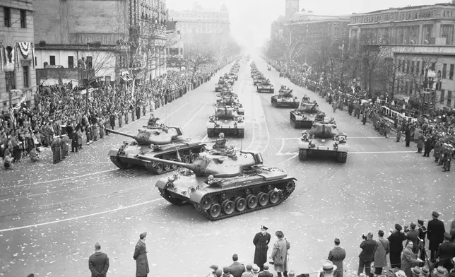 FILE - Army medium tanks move along Pennsylvania Avenue during the Inaugural Parade for President Dwight D. Eisenhower, Jan. 21, 1953, in Washington. Front tanks are turning into 15th Street on way to the reviewing stand set up in front of White House. (AP Photo, File)