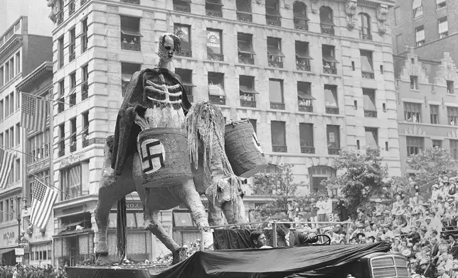 FILE - One of the floats in New York's war parade depicting Hitler in deaths' garb, rolls down Fifth Avenue in New York, June 13, 1942. (AP Photo, File)