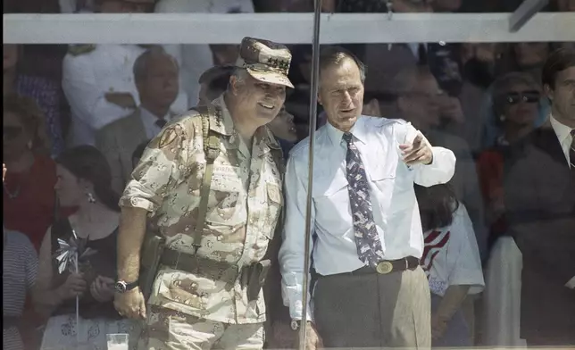 FILE - Gen. Norman Schwarzkopf, left, and President George HW Bush watch the National Victory Parade in Washington, June 8, 1991, after Schwarzkopf led his troops in the parade, and then joined Bush in the reviewing stand. (AP Photo/Ron Edmonds, File)